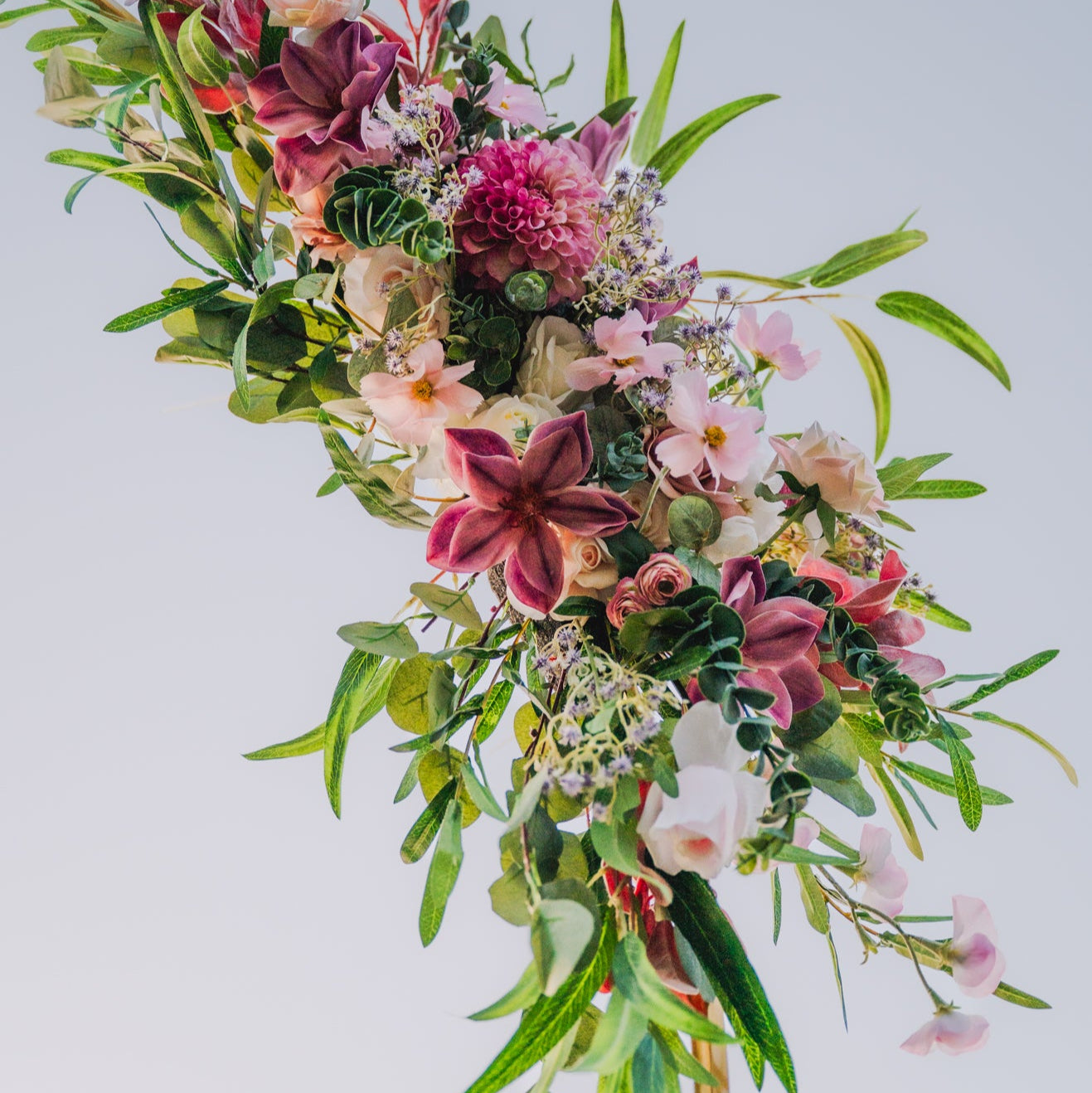 Floral arrangement with pink, white, and green flowers on a light gray background
