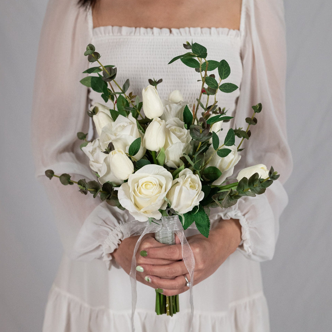 Captivating white bouquet with enchanting colors, blending timeless elegance of roses and delightful beauty of tulips. Perfect for weddings, anniversaries, or joyous moments.&quot;