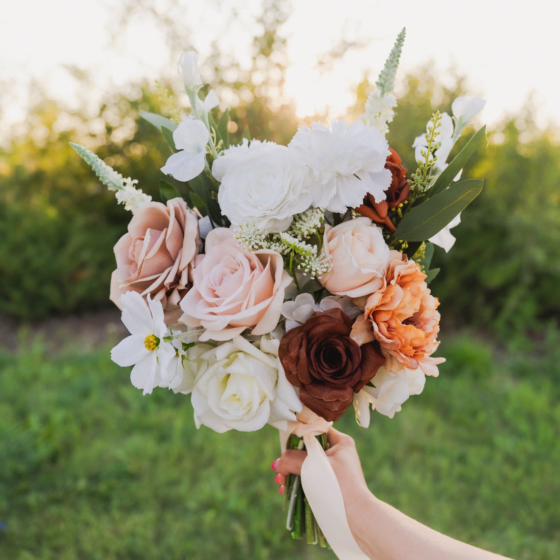 A warm and romantic bridal bouquet featuring soft mocha, ivory, and caramel-toned faux florals. Blushed Terra blends roses, ranunculus, and textural blooms for an earthy, elevated look that pairs beautifully with neutrals, rust, or terracotta.
