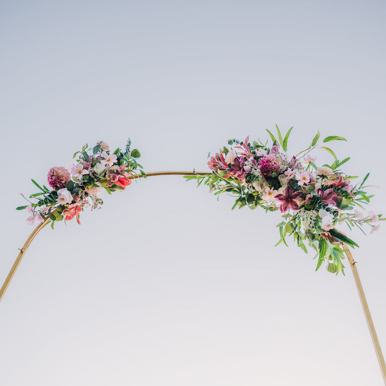 Floral arch against a clear blue sky