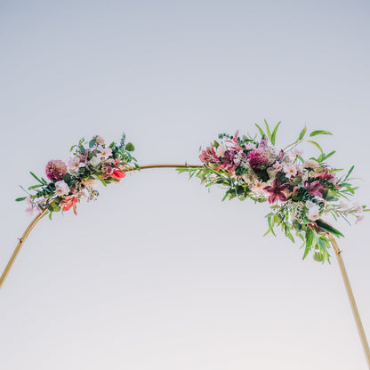 Floral arch against a clear blue sky