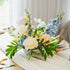 Pastel artificial wedding centerpiece with silk roses, faux hydrangea, and greenery on a guest table, Edmonton event rentals.