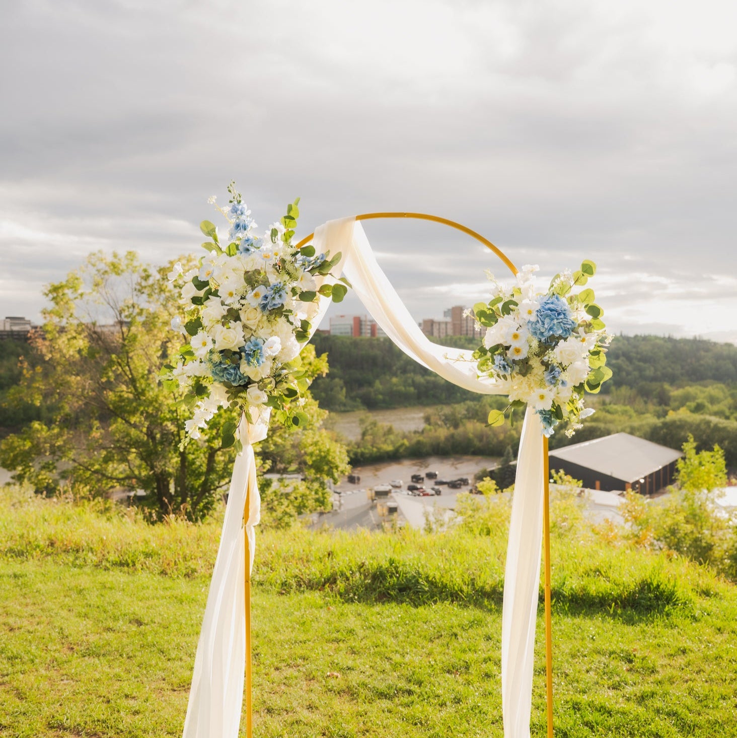 Decorative Ocean Breeze arch duo on an arch frame and sash set against a scenic background near the River Valley in Edmonton, Alberta.