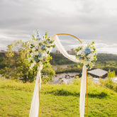 Decorative Ocean Breeze arch duo on an arch frame and sash set against a scenic background near the River Valley in Edmonton, Alberta.