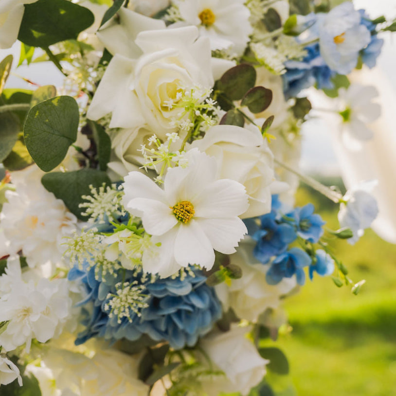Close up of faux, artificial, real touch and silk flowers in whites and blue.