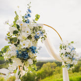 Ocean Breeze floral arch with white and blue flowers in an outdoor setting.
