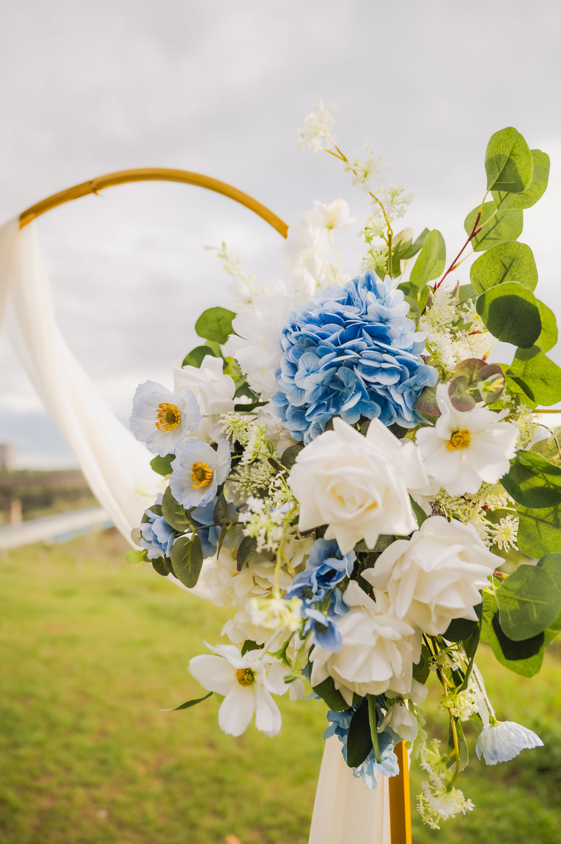 Floral arrangement with blue and white flowers on a blurred natural background in Edmonton, Alberta for weddings and other special events.