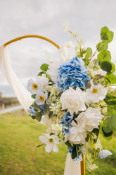 Floral arrangement with blue and white flowers on a blurred natural background in Edmonton, Alberta for weddings and other special events.