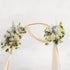 Decorative arch with floral arrangements against a clear sky