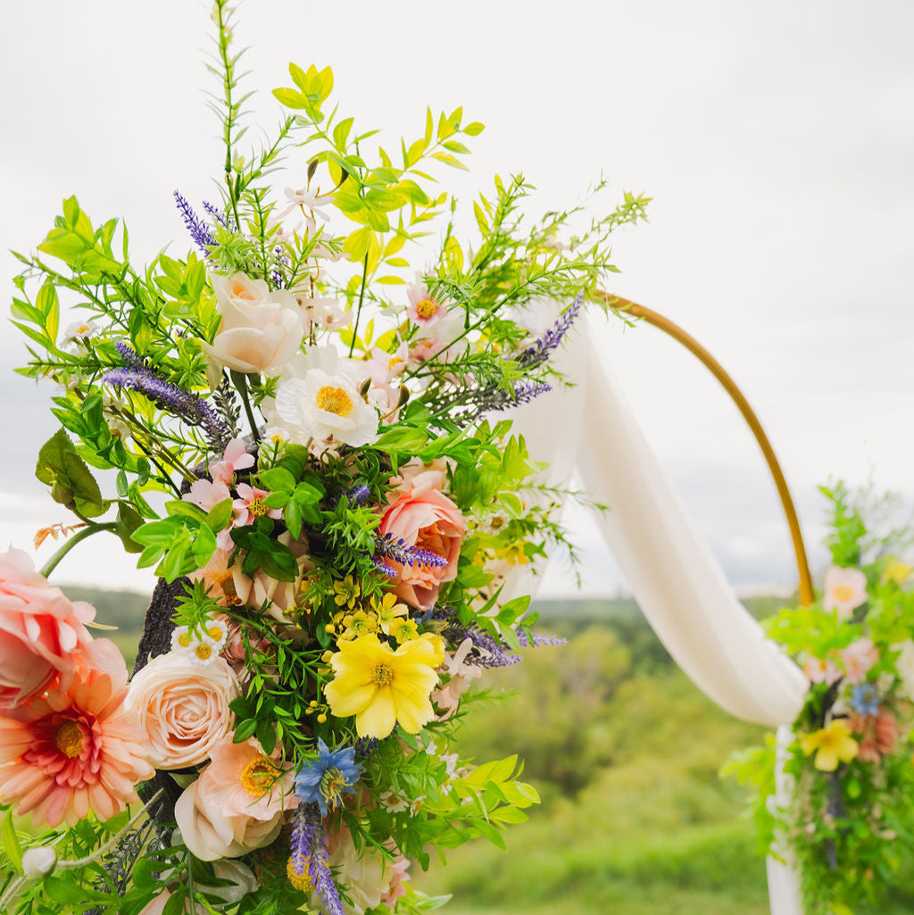 Close up of our Wildest Dreams two-piece arch faux (artificial) flowers on an arch frame.
