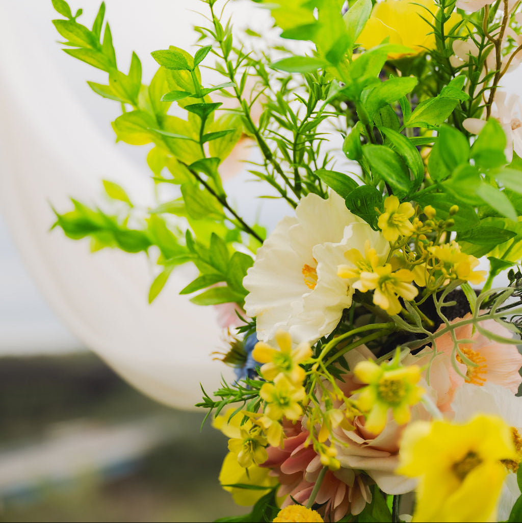 Close up of our Wildest Dreams two-piece arch faux (artificial) flowers on an arch frame.