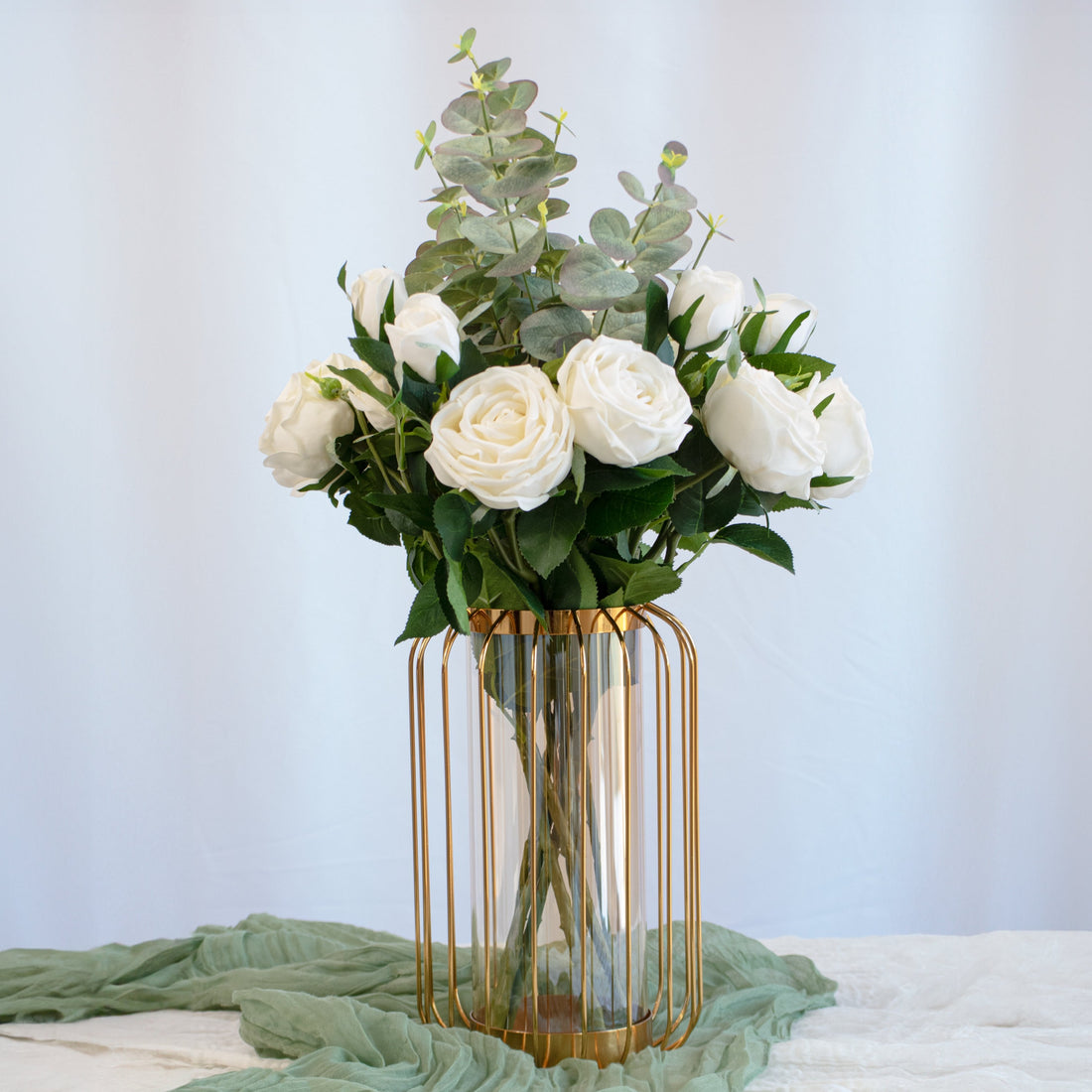 Large vase centerpiece with tall glass vase, and a gold metal frames, and realistic &