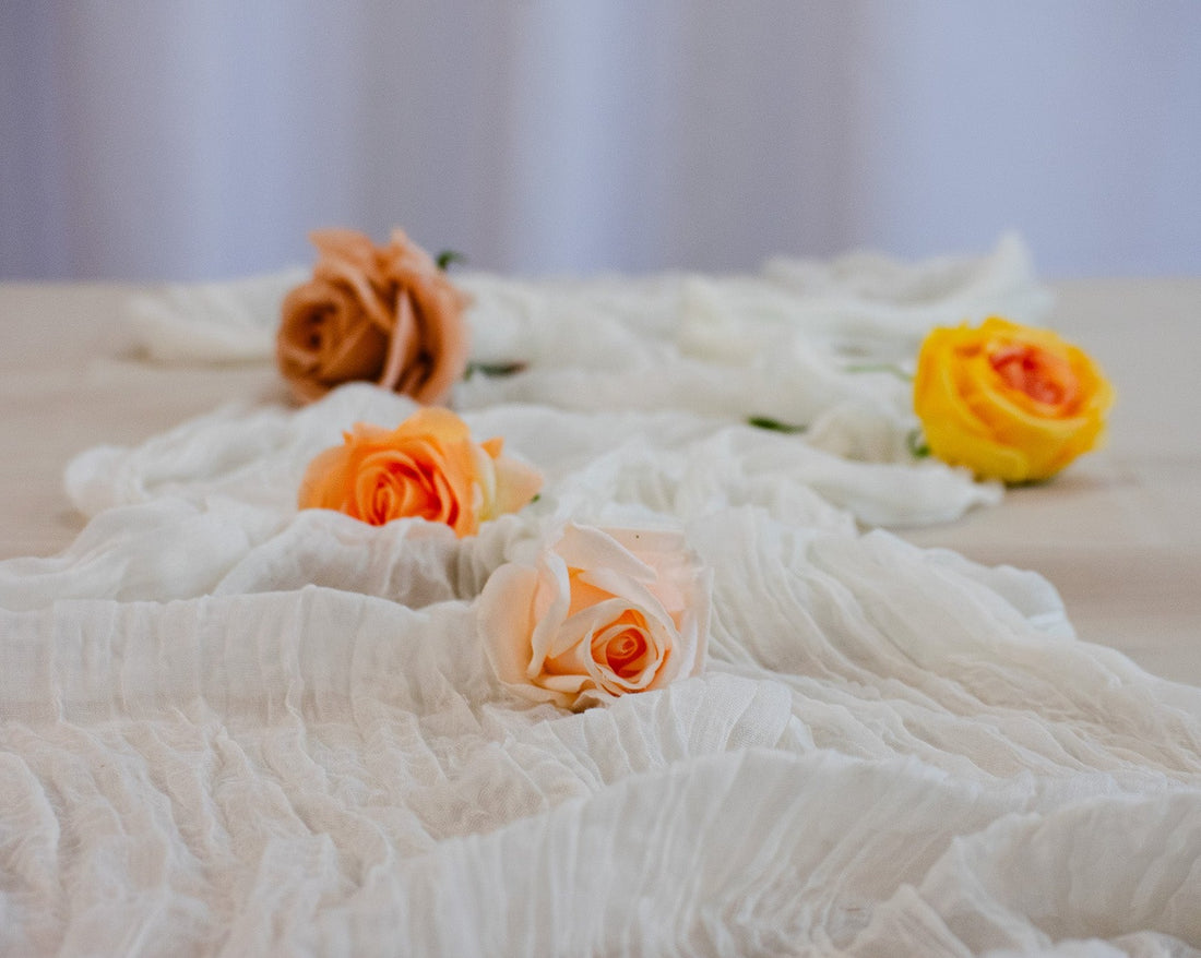 Elegant white table runner for up to 10 guests. Delicate gauze pattern and timeless white hue create a romantic atmosphere. Perfect for weddings, baby showers, and celebrations. Available for rentals in Edmonton, Sherwood Park, Leduc, St. Albert.