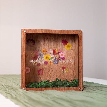 Nature-inspired dried florals in a wooden box adorn with a uniquely crafted piece of clear plexiglass window, perfect for displaying well-wishing cards at weddings, anniversaries, and cherished celebrations.