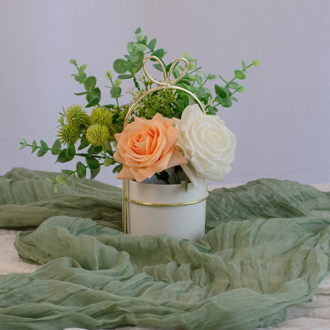8in tall, 9in wide centerpiece with lifelike roses and eucalyptus, ideal for table decor. Available for rent in Edmonton, Sherwood Park, Leduc, and St. Albert, Alberta
