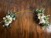 Light brown floral silk and real touch arch on a wooden floor