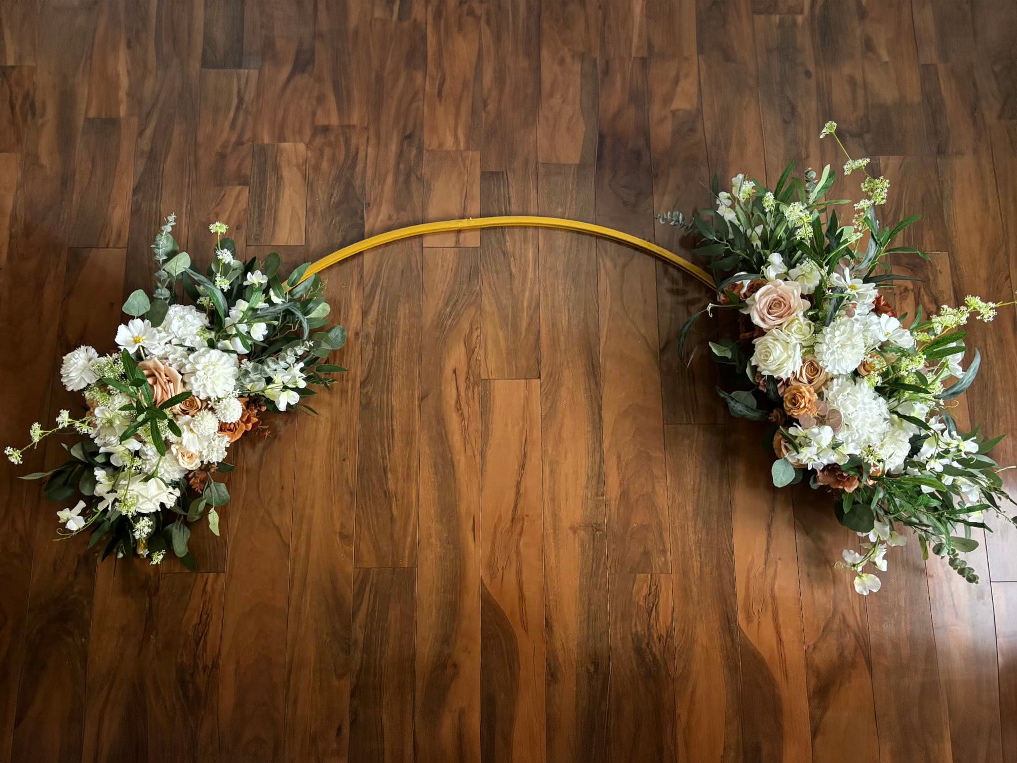 Light brown floral silk and real touch arch on a wooden floor