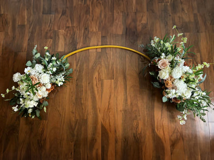 Light brown floral silk and real touch arch on a wooden floor